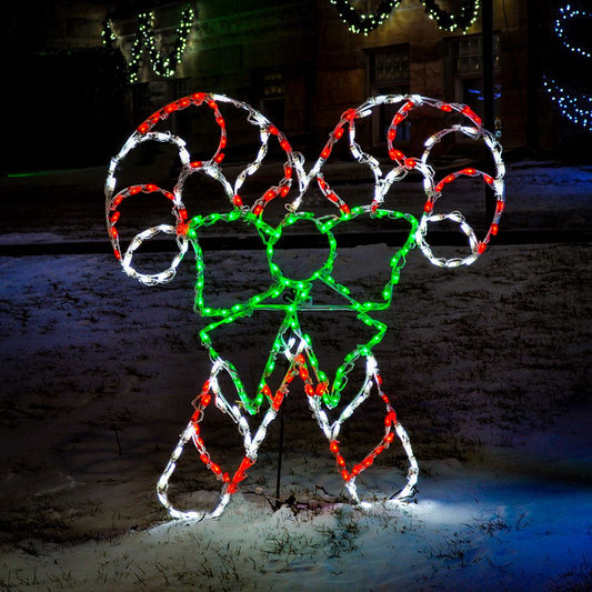 Double Candy Canes with Green Bow LED Display glowing in red, white, and green LEDs in a snowy front yard at night