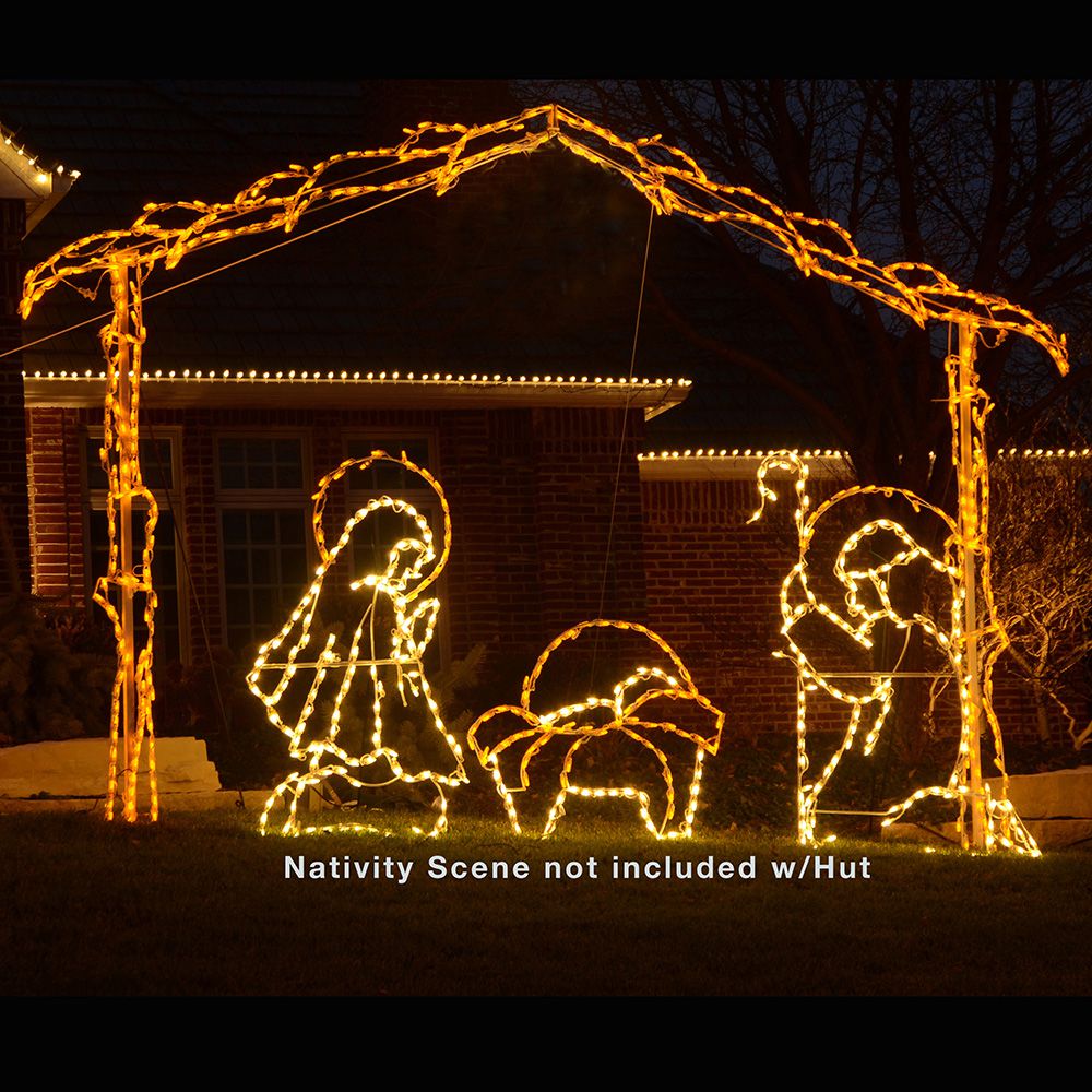 Nativity Scene Hut LED display installed in front yard at night, yellow stable arch framing a full nativity scene with Mary, Joseph, and baby Jesus in manger