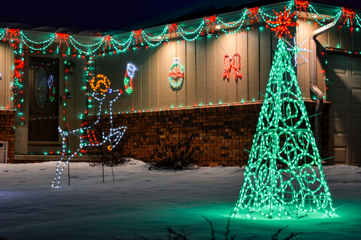 Home trimmed in Linkables with a lighted tree and reindeer display in the snow