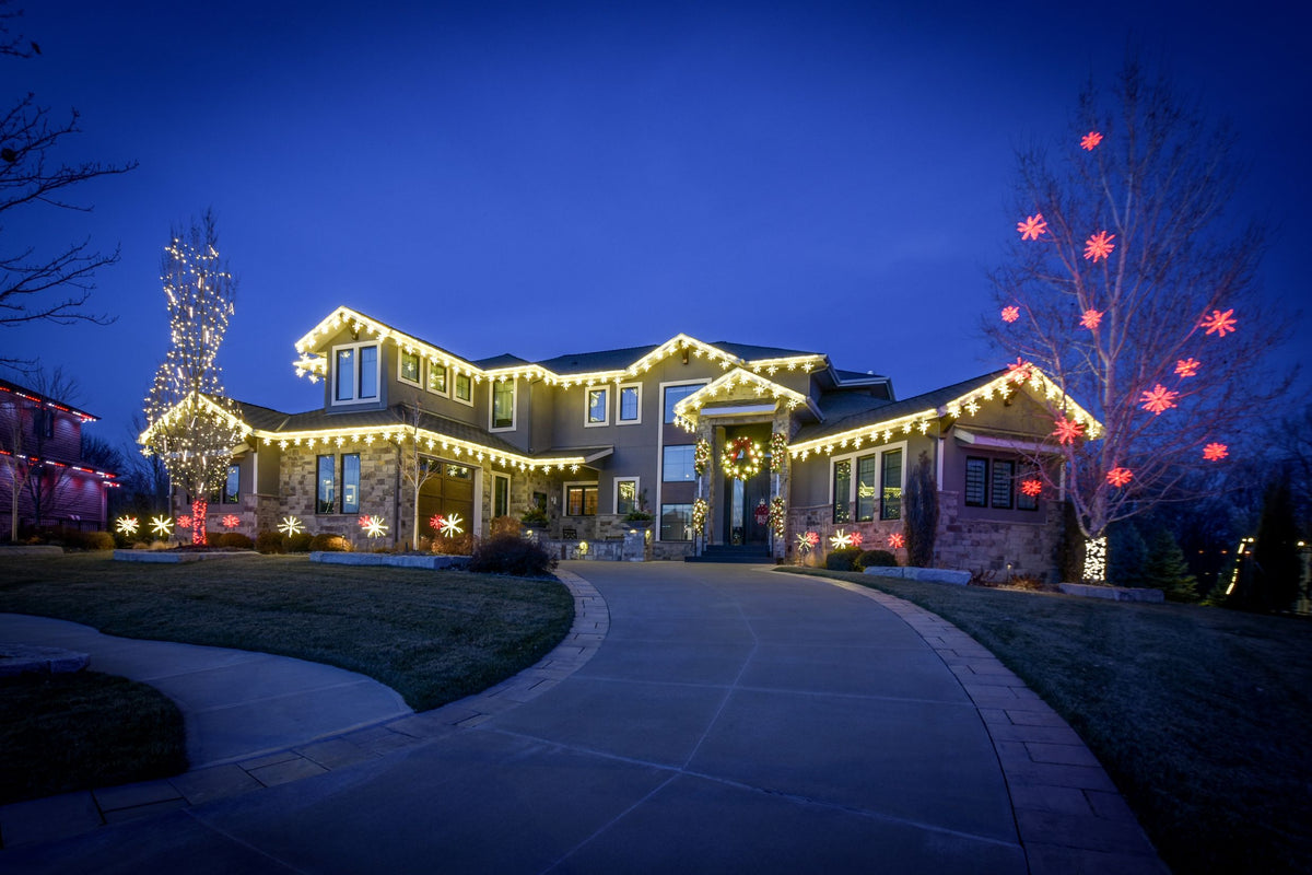 Home outlined in warm white Linkables with a lighted walkway and starburst tree