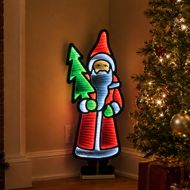 A glowing Santa Claus LED light sign stands in a warmly lit living room beside a decorated Christmas tree and wrapped presents.